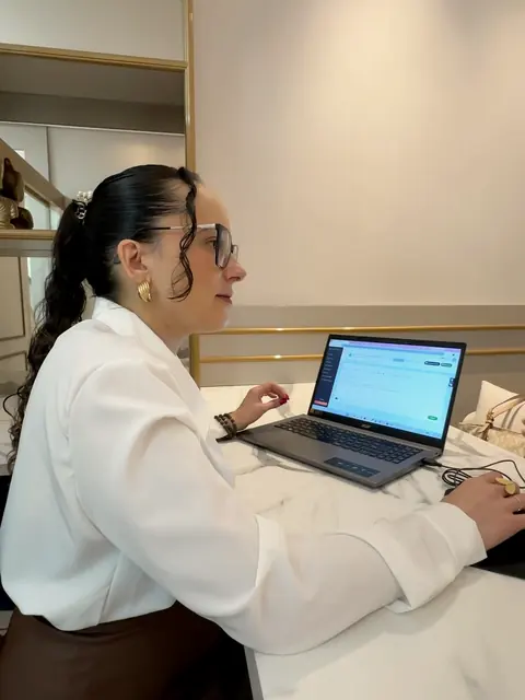 Camila Garcia, nutricionista, ao computador durante a bioimpedância